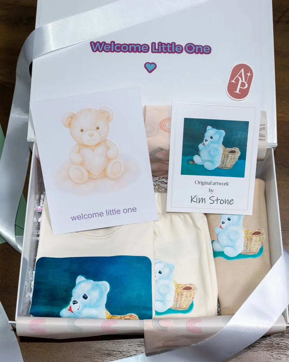 Personalized new baby apparel, matching card and coordinated gift box