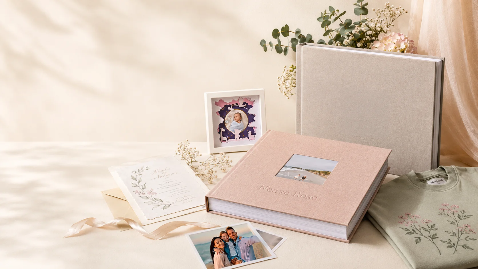 Avenoir composition with keepsake album, layered frame, invitation, family photographs and embroidered floral shirt